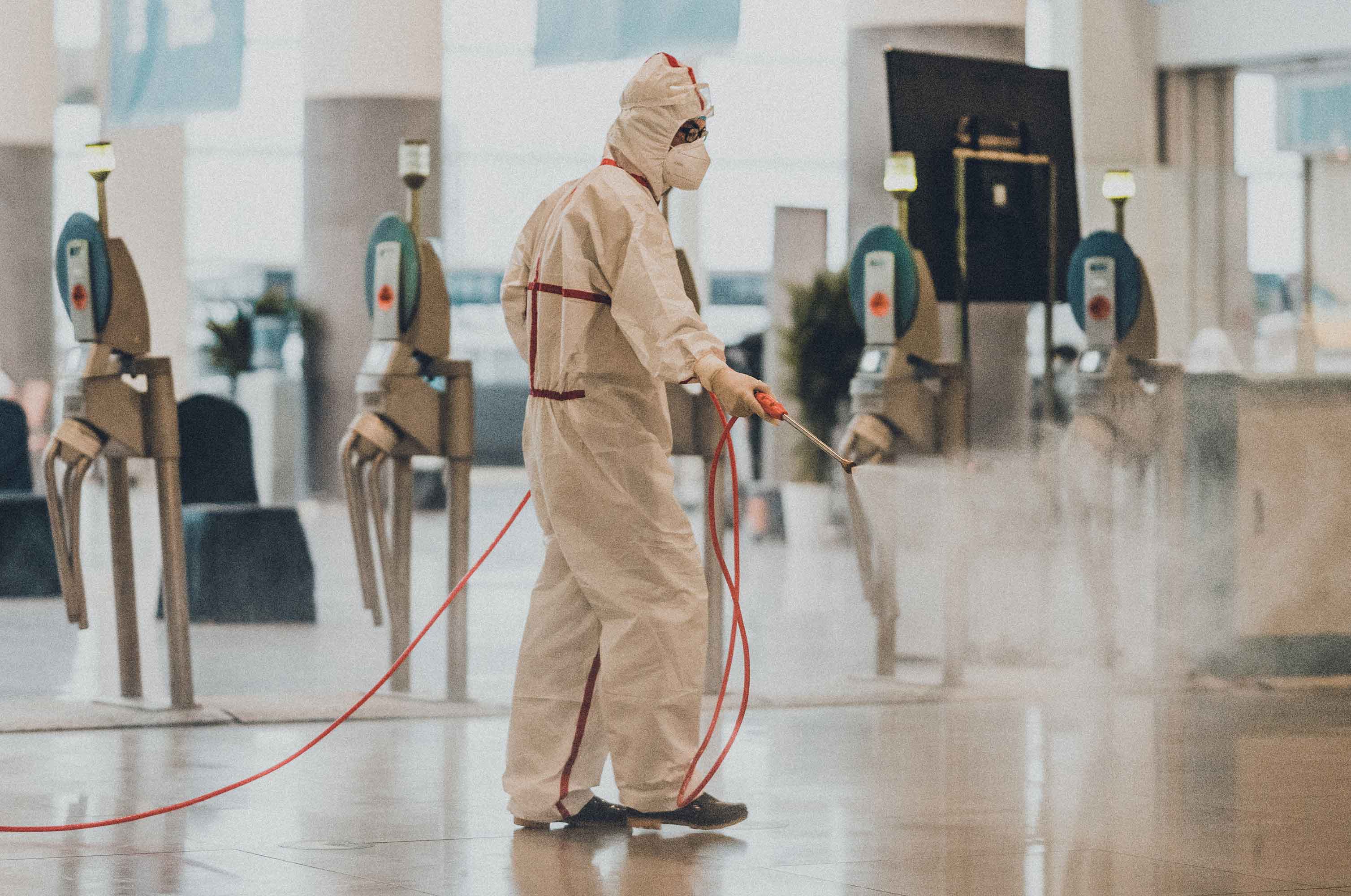 healthcare worker spraying sanitizing aerosol  